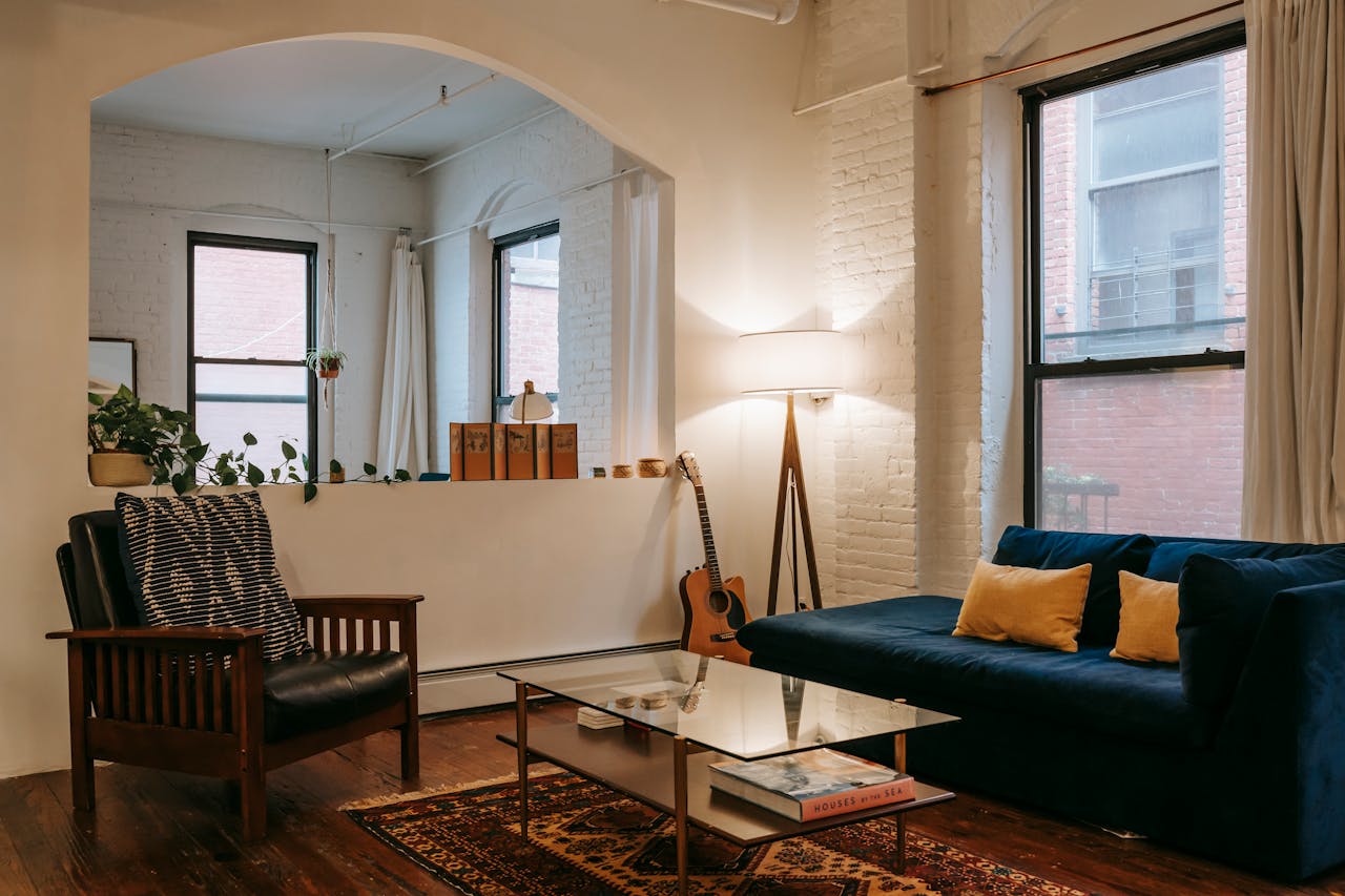 A stylish living room featuring contemporary furniture, warm lighting, and decorative elements.